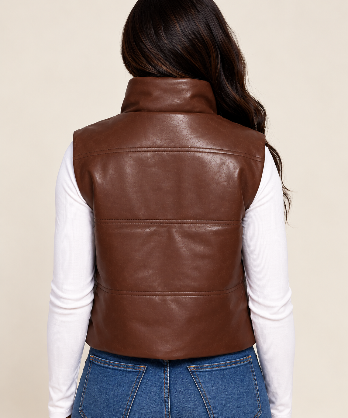 Woman modeling the back view of the Faux leather brown vest.