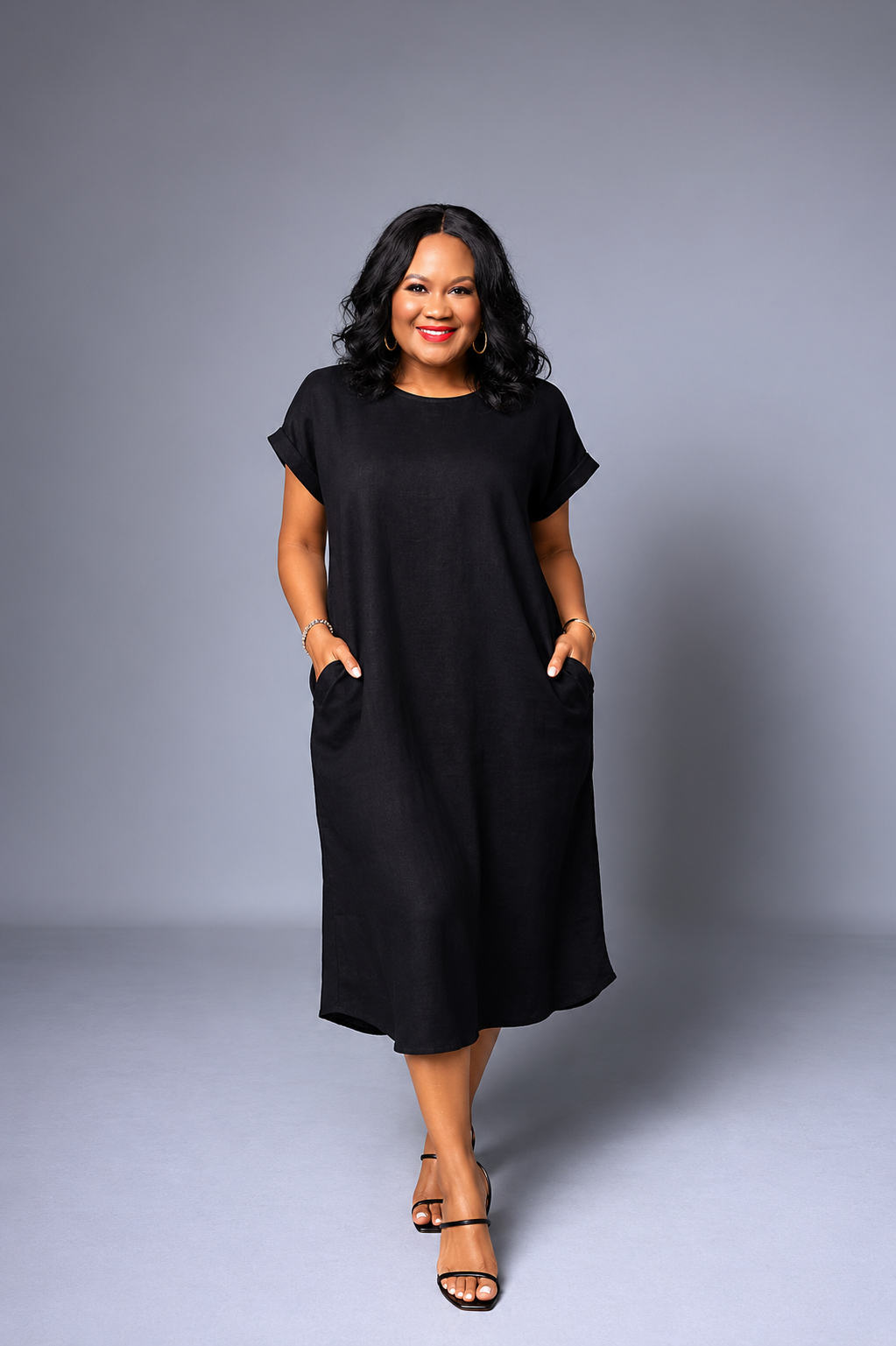 Woman wearing a black dress against a gray background