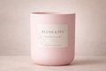Pink candle with 'Blush & Ivy' label on a beige background