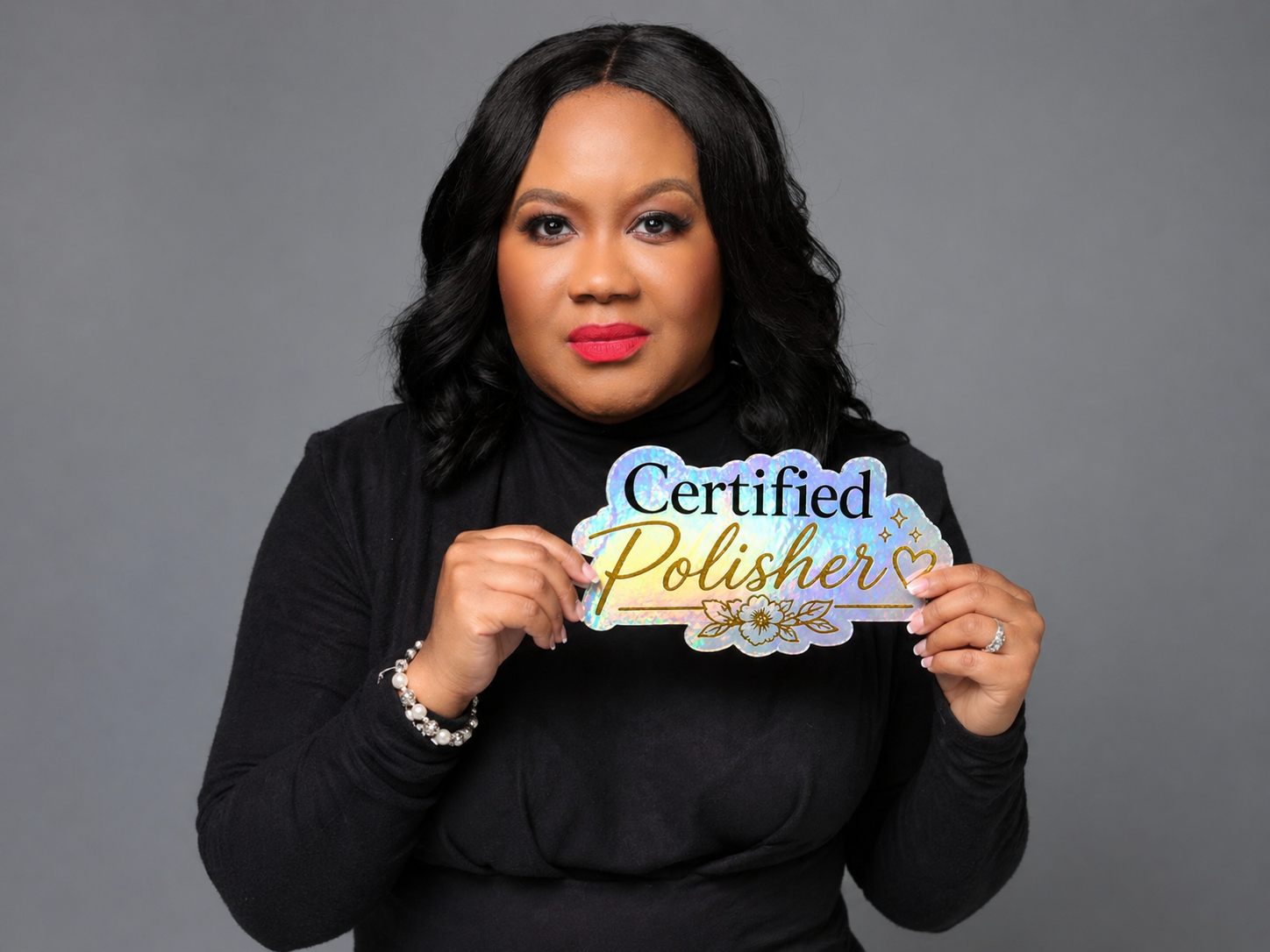 Woman holding a 'Certified Polisher' sign against a gray background