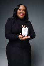 Woman holding a product against a gray background