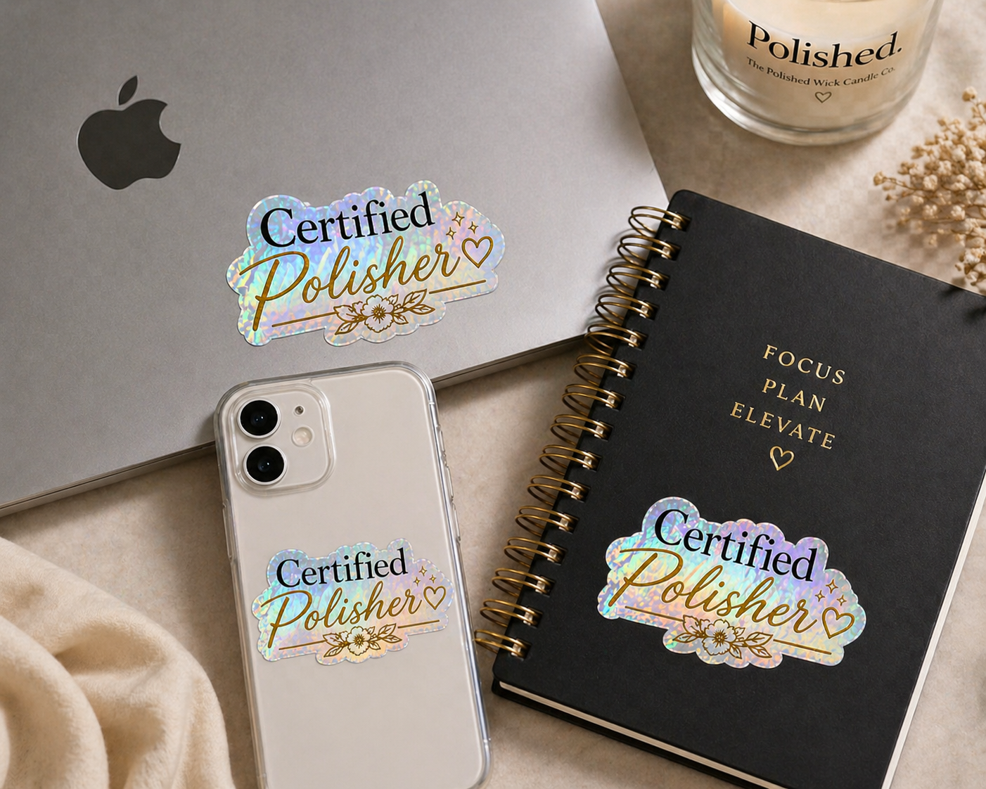 Phone with 'Certified Polisher' sticker, black notebook, and bottle on a light surface
