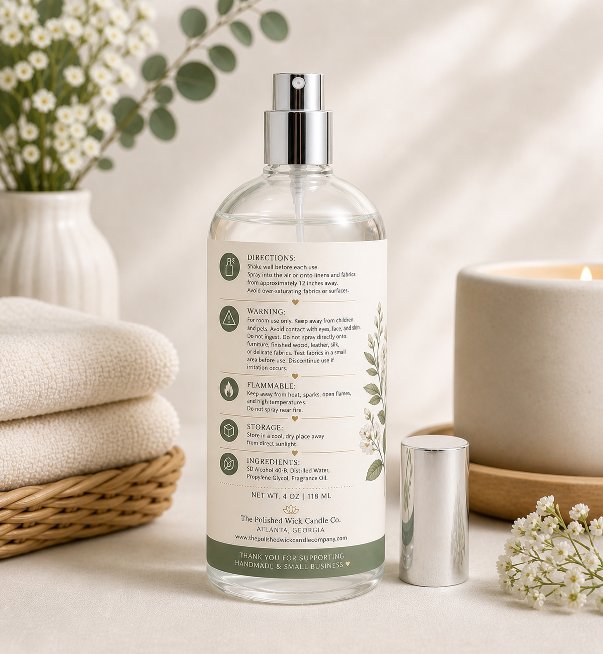Clear bottle with label on a neutral background with decorative elements