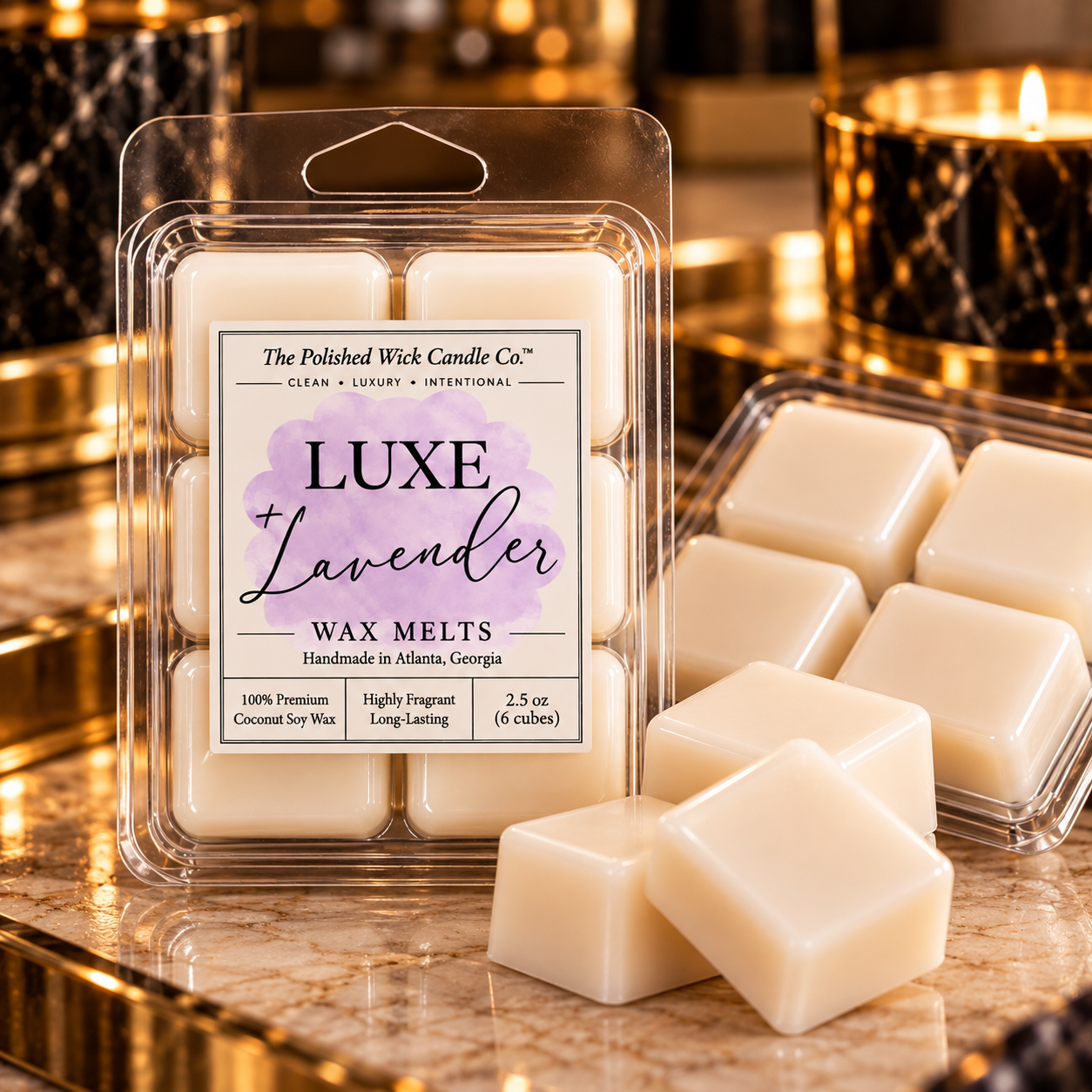 A package of Luxe Lavender wax melts by The Polished Wick Candle Co. is shown in a clear plastic clamshell with several off-white wax cubes in front, alongside an open tray of loose wax melts on a warm, reflective marble surface with candles in the background.