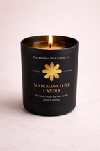 Black candle with a yellow flower logo and text on a light pink background