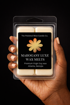 Hand holding a package of Mahogany Luxe wax melts by The Polished Wick Candle Co. on a black background.