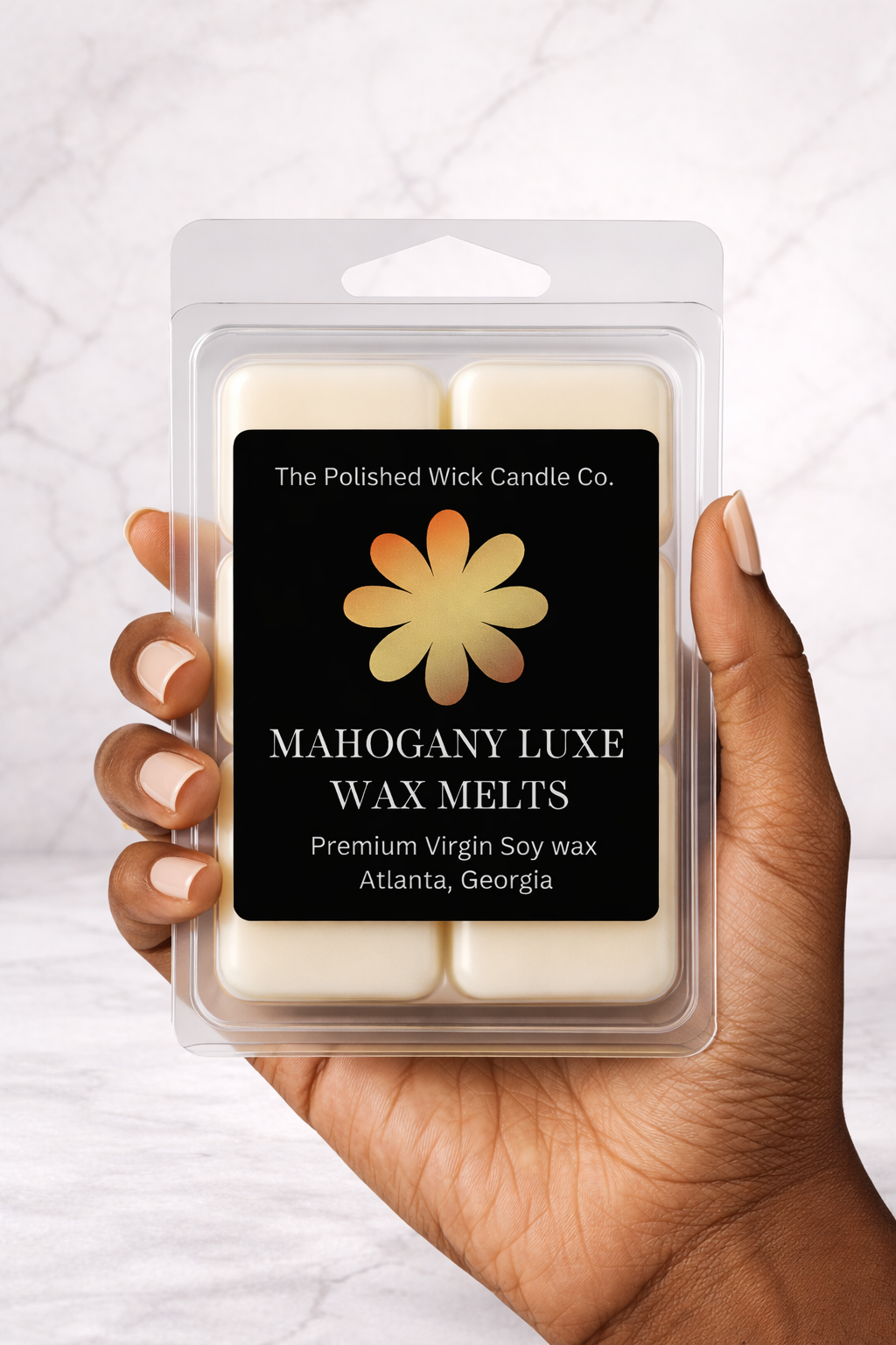 Mahogany luxe wax melts with melanin hand holding the wax melts in a simple background