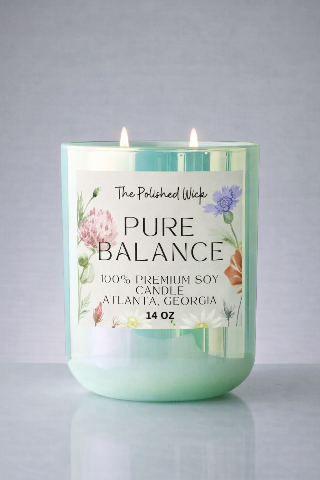 Candle labeled 'Pure Balance' by The Polished Wick on a gray background