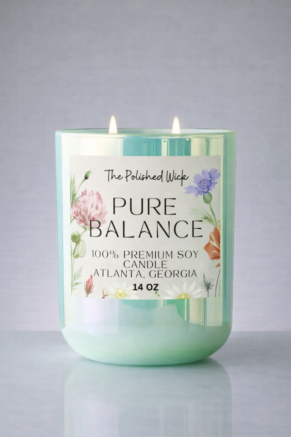 Candle labeled 'Pure Balance' by The Polished Wick on a gray background