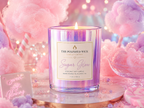 Candle labeled 'Sugar Glow' from The Polished Wick Candle Company on a pink and purple cotton candy background.