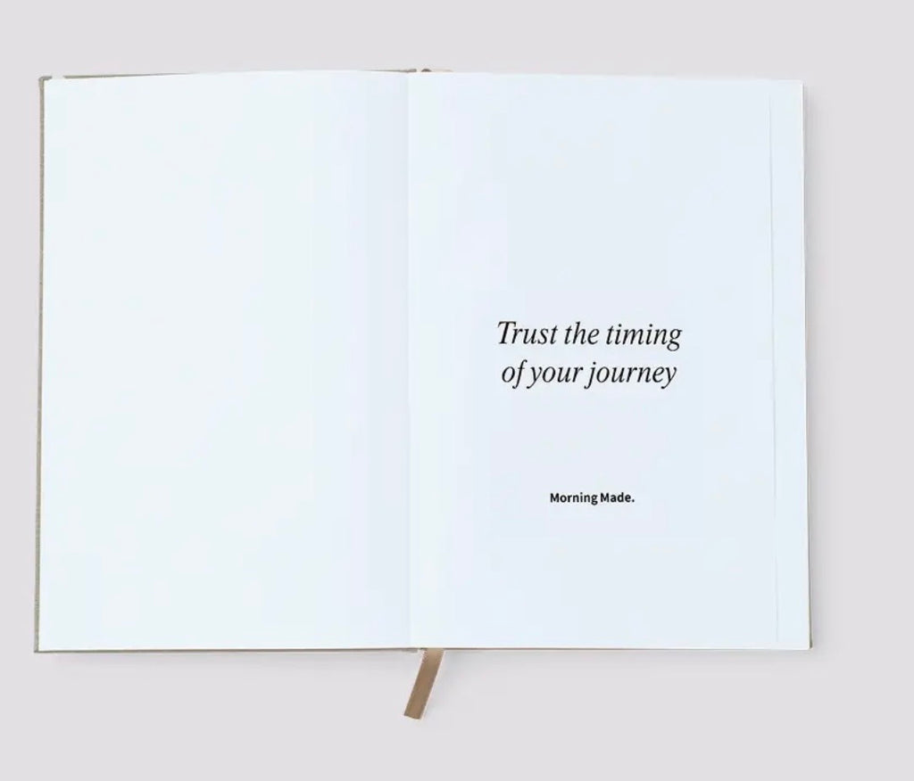 Open book with a motivational quote on a plain background