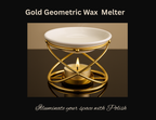 Gold geometric wax melter with a lit candle on a reflective surface