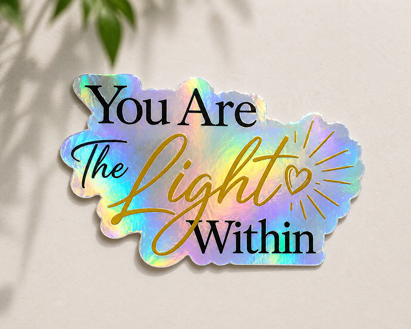 Holographic sticker with 'You Are The Light Within' text on a neutral background
