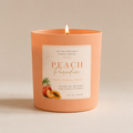 Peach-colored candle with a label on a beige background