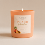 Peach-colored candle with a label on a beige background