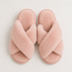 Pair of pink fuzzy slippers on a light gray background